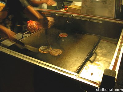 man burger cooking